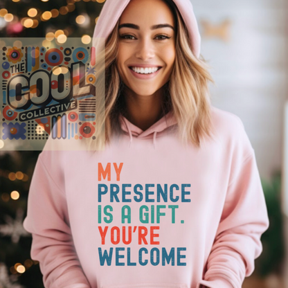 A unisex retro-style hoodie with the phrase “My Presence Is A Gift. You’re Welcome.” Perfect for confident personalities, sassy gift-givers, and bold statement lovers.